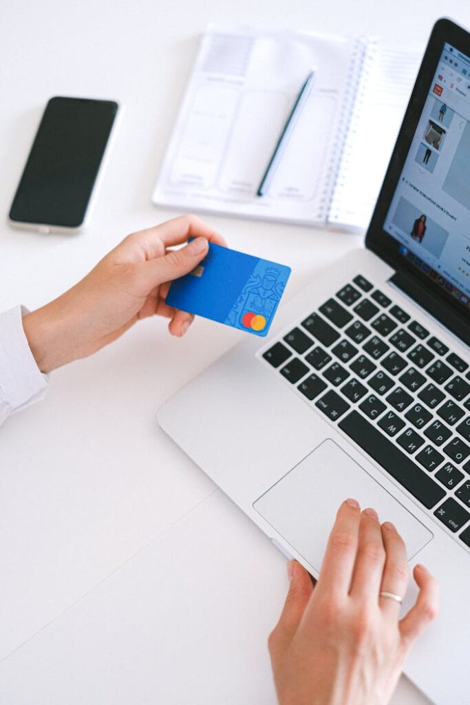pexels-photo-4482900-1 Person making an online purchase with a credit card on a laptop, showcasing modern ecommerce technology.