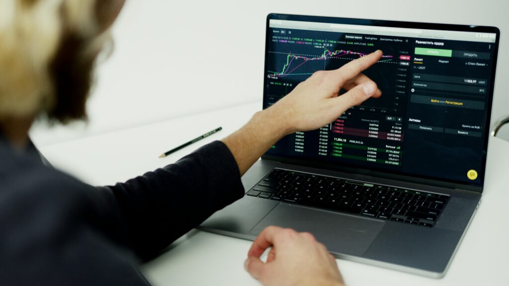 pexels-photo-5716052-5716052 A person analyzing stock market graphs on a laptop screen, showcasing trading insights.